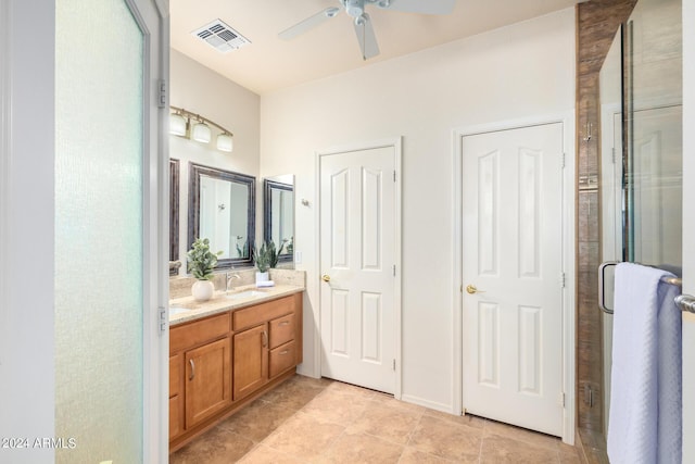 bathroom with walk in shower, ceiling fan, and vanity