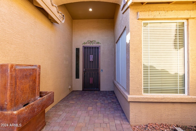 view of exterior entry featuring a patio