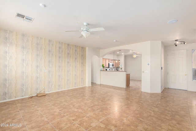 interior space with ceiling fan