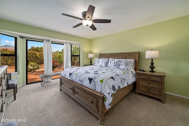 bedroom with baseboards, light carpet, and access to outside