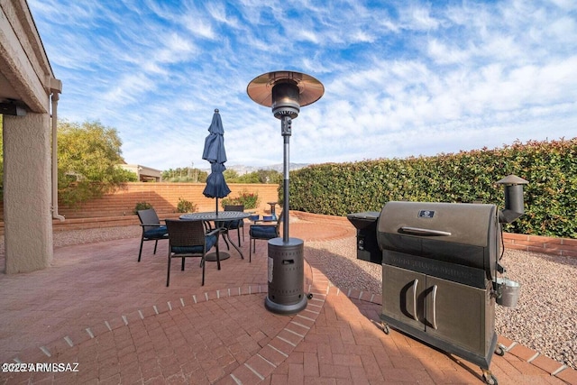 view of patio / terrace with outdoor dining space, grilling area, and fence