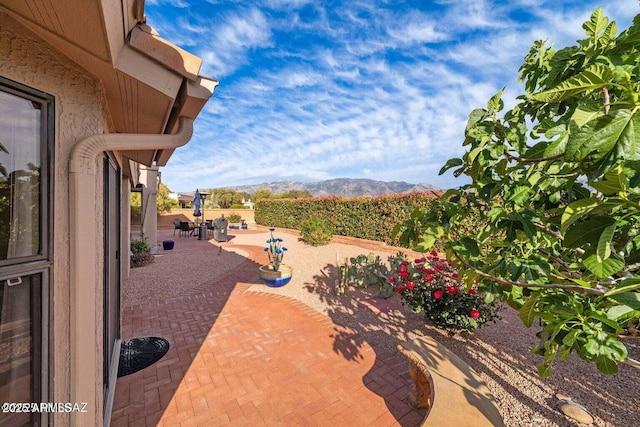 view of patio with outdoor dining space and a mountain view
