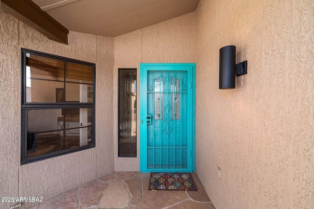 property entrance with stucco siding