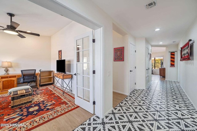 corridor featuring wood finished floors, visible vents, recessed lighting, and baseboards
