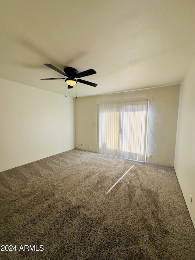 unfurnished room featuring carpet flooring and ceiling fan