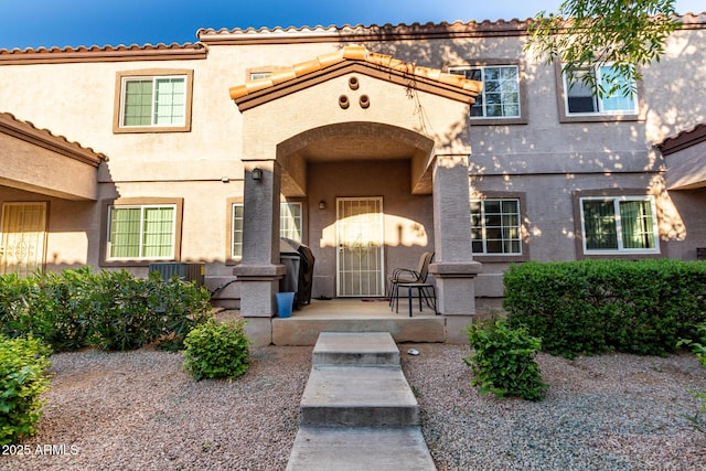 property entrance with stucco siding