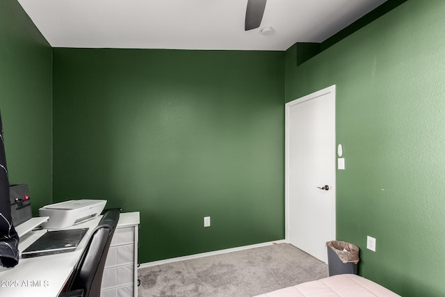 home office featuring light colored carpet, ceiling fan, and baseboards