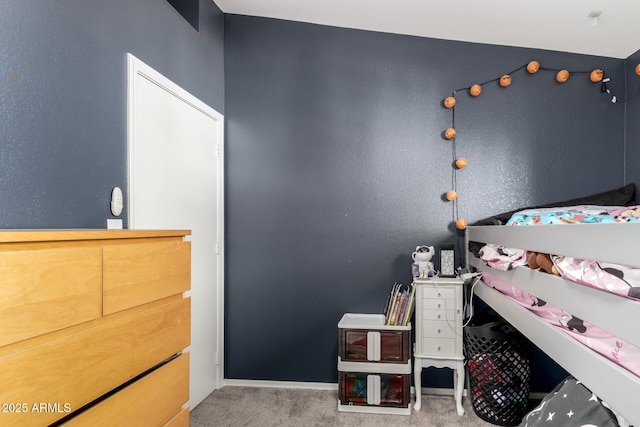 carpeted bedroom featuring baseboards