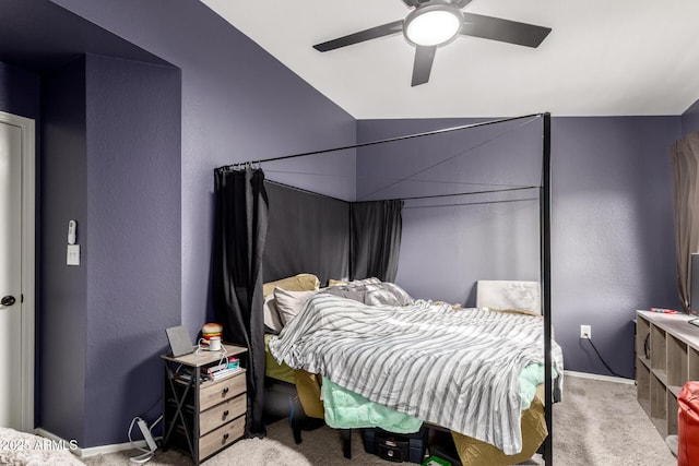 carpeted bedroom with baseboards, ceiling fan, and a textured wall
