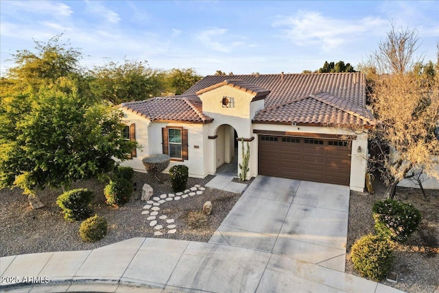 mediterranean / spanish house with a garage