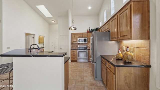 kitchen featuring dark countertops, brown cabinets, and stainless steel appliances