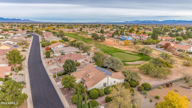 drone / aerial view featuring view of golf course, a residential view, and a mountain view