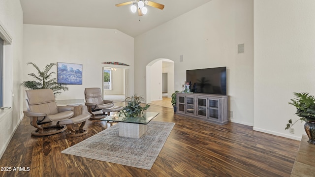 living area featuring arched walkways, dark wood-style flooring, visible vents, ceiling fan, and baseboards