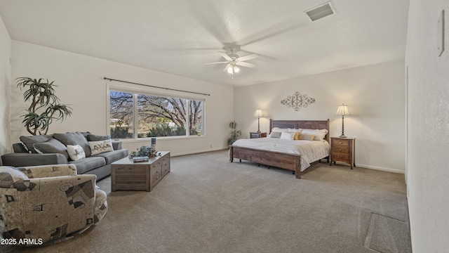 bedroom featuring visible vents, a ceiling fan, light carpet, a textured ceiling, and baseboards