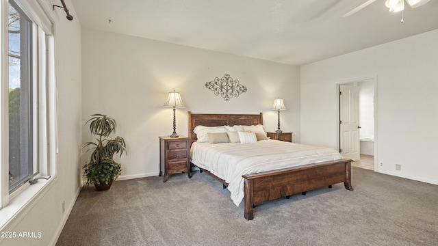 bedroom with carpet, baseboards, and ensuite bath