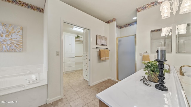 bathroom with tile patterned flooring, a garden tub, vanity, baseboards, and a stall shower