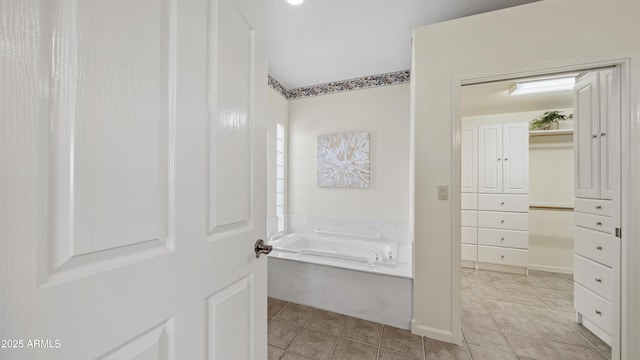 full bath with a garden tub, tile patterned flooring, and a closet