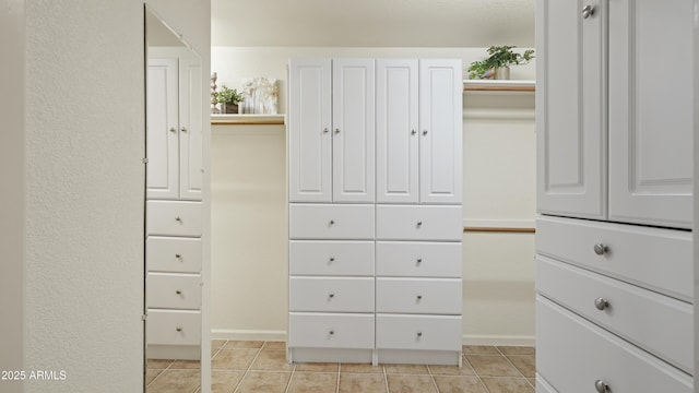 spacious closet with light tile patterned floors