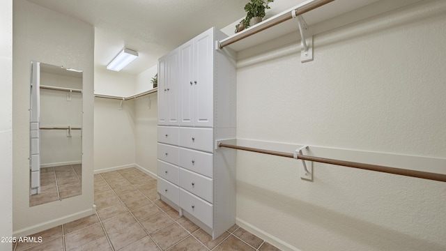 walk in closet featuring light tile patterned flooring