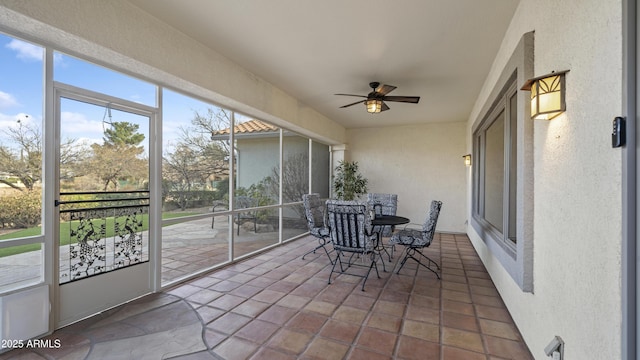 sunroom featuring a ceiling fan