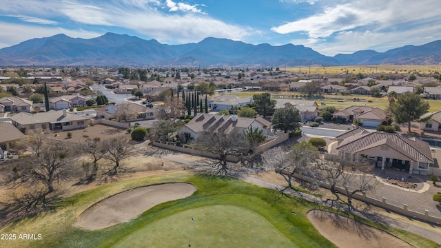 aerial view with view of golf course, a residential view, and a mountain view