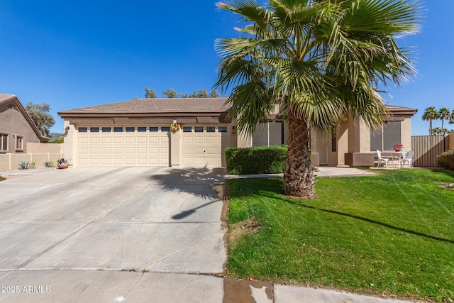 view of front of home with a front yard and a garage