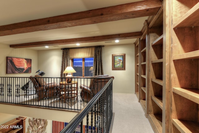 hallway with beam ceiling and carpet