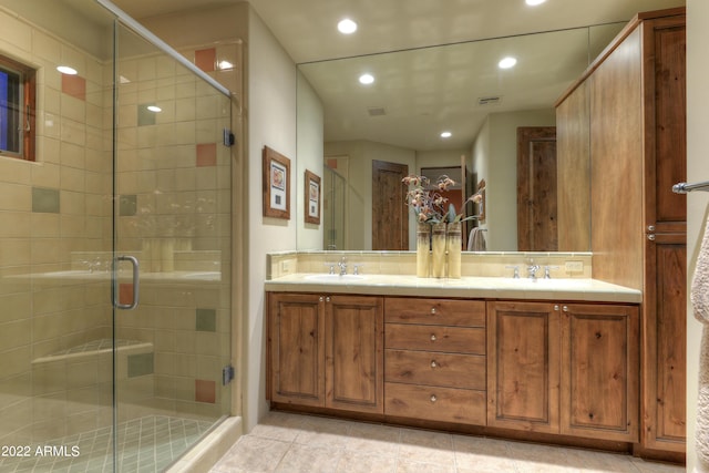 bathroom with tasteful backsplash, vanity, an enclosed shower, and tile patterned floors