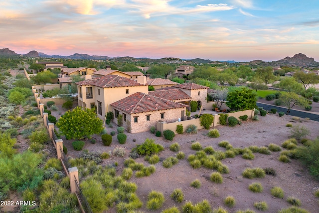 aerial view at dusk featuring a mountain view