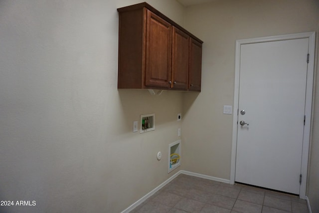 laundry room featuring cabinets, hookup for a washing machine, electric dryer hookup, light tile patterned floors, and hookup for a gas dryer