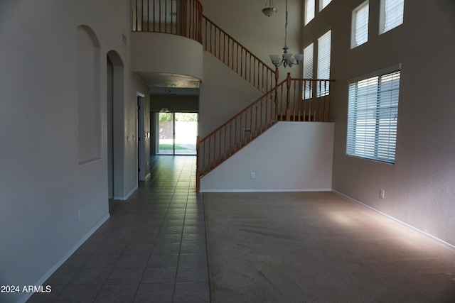 interior space featuring a notable chandelier and a high ceiling