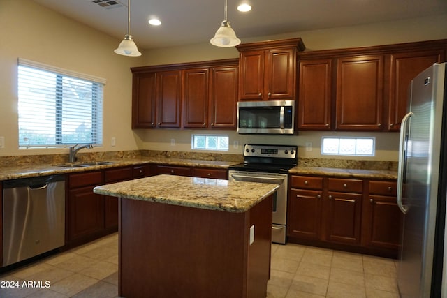 kitchen featuring sink, a center island, pendant lighting, and appliances with stainless steel finishes