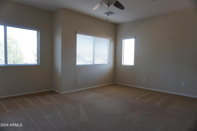 spare room with carpet flooring and ceiling fan