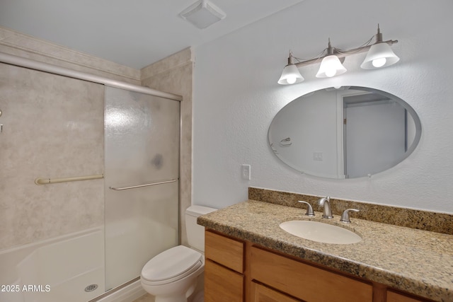 bathroom featuring toilet, walk in shower, and vanity