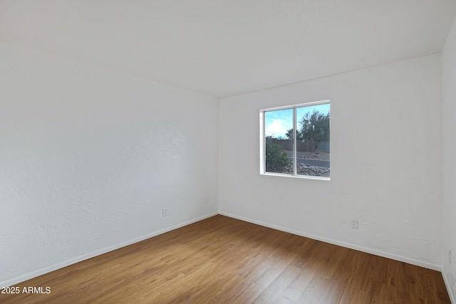 spare room featuring hardwood / wood-style flooring