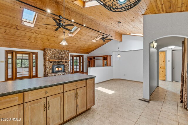 17620 Littlefield Pl, Munds Park, AZ 86017 - kitchen featuring a skylight, a ceiling fan, wood ceiling, healthy amount of natural light, and dark countertops