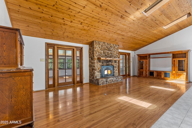 17620 Littlefield Pl, Munds Park, AZ 86017 - unfurnished living room featuring wood ceiling, wood finished floors, a stone fireplace, high vaulted ceiling, and french doors