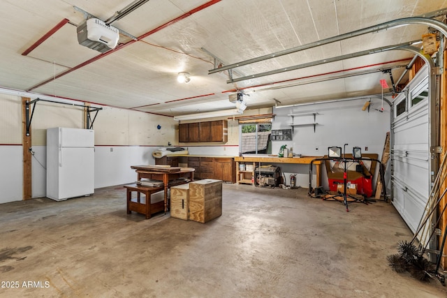 17620 Littlefield Pl, Munds Park, AZ 86017 - garage with freestanding refrigerator, a garage door opener, and a workshop area