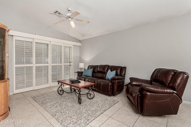 living area with vaulted ceiling, light tile patterned flooring, and ceiling fan