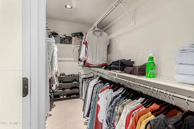 walk in closet with tile patterned floors