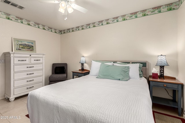 bedroom featuring light tile patterned floors, visible vents, and ceiling fan