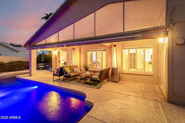 pool at dusk featuring an outdoor living space, a fenced in pool, and a patio