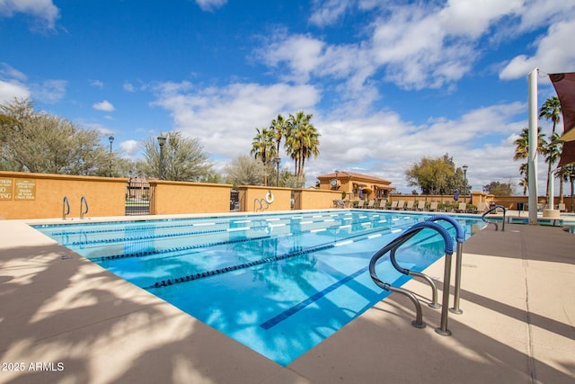 pool featuring a patio and fence