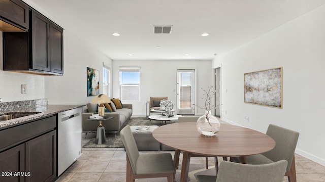 dining space with sink and light tile patterned floors