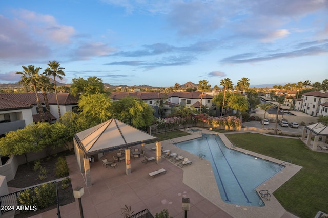 view of swimming pool featuring a lawn, a gazebo, and a patio