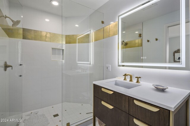 bathroom with a shower with door and vanity