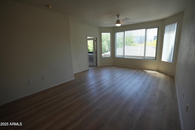 435 W Rio Salado Pkwy Unit 210, Tempe, AZ 85281 - spare room with baseboards, dark wood-style flooring, a ceiling fan, and a wealth of natural light