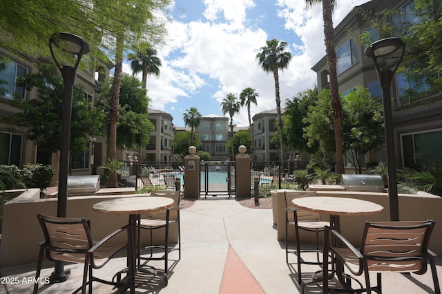 435 W Rio Salado Pkwy Unit 210, Tempe, AZ 85281 - view of patio featuring grilling area, a community pool, and fence