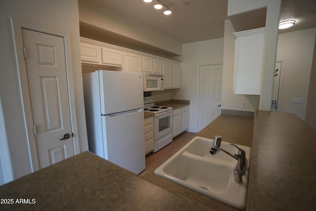 435 W Rio Salado Pkwy Unit 210, Tempe, AZ 85281 - kitchen with white cabinets, wood finished floors, white appliances, and a sink