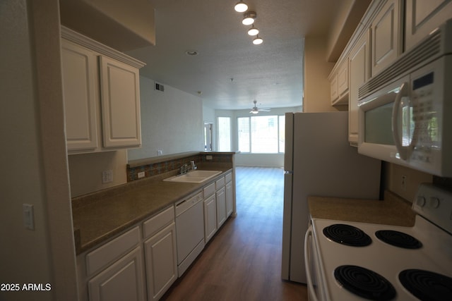 435 W Rio Salado Pkwy Unit 210, Tempe, AZ 85281 - kitchen with white cabinets, a peninsula, a sink, dark wood-style flooring, and white appliances